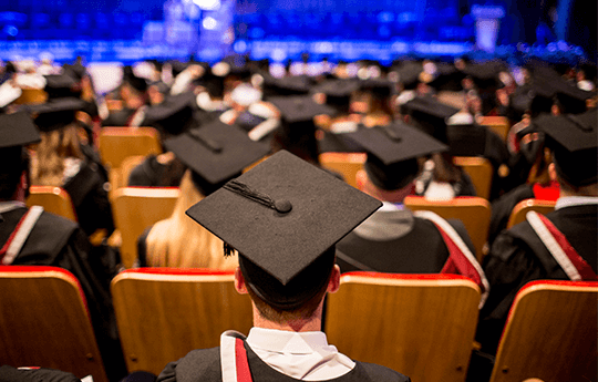 A view of the backs graduates of graduates in their caps during their graduation congregation