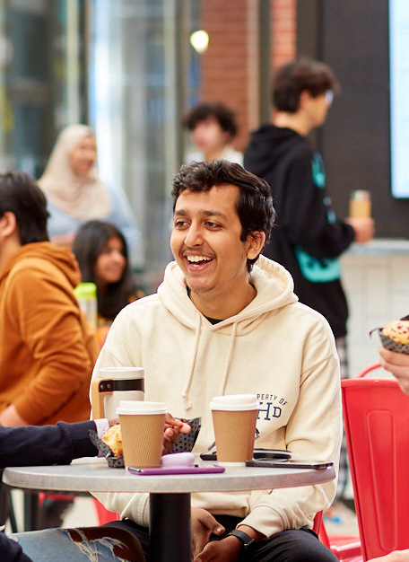 student smiling sat down.