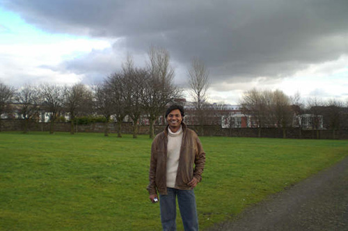 Student smiling at camera outside