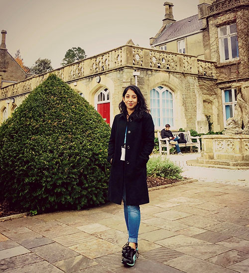 student standing outside the Abbey looking at the camera