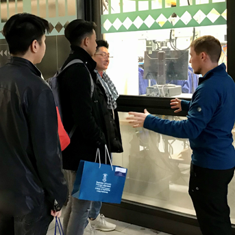 Malaysian father and two sons talking to a student ambassador in Swansea university 