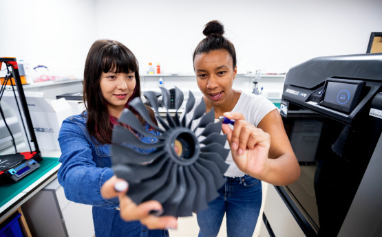 Two female Aerospace Engineering students in the lab.