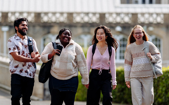Four students walking together on Singleton Campus