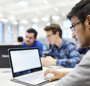 Student in library on laptop.