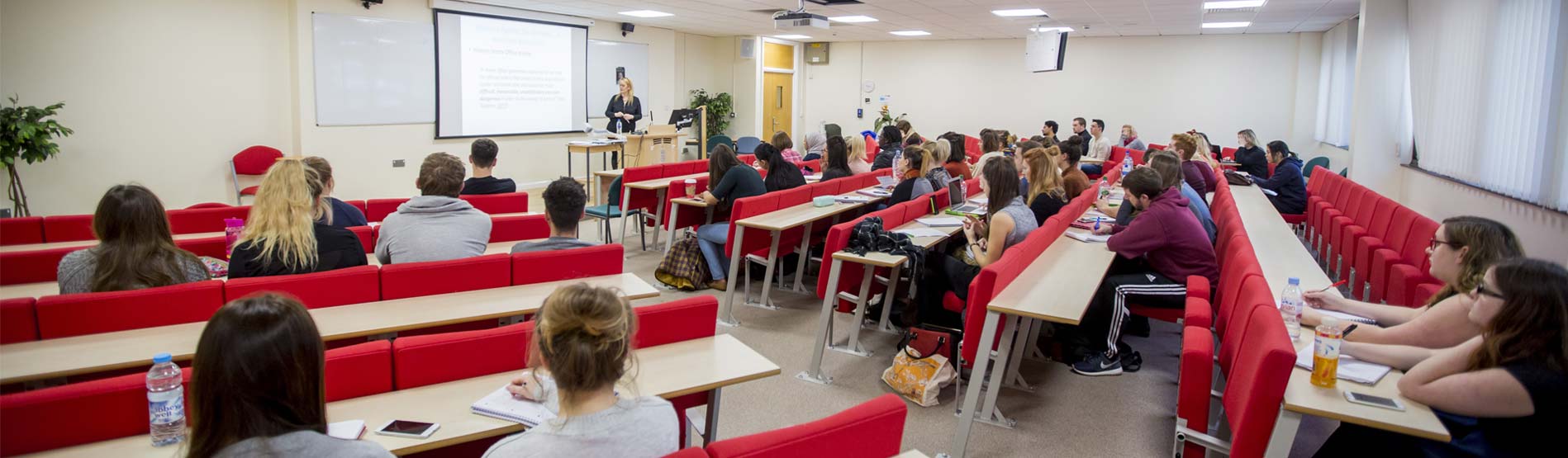 student in the lecture theatre at swansea university