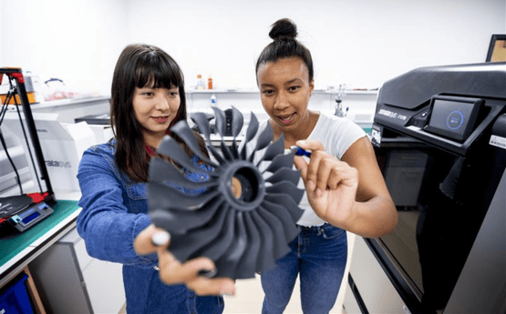 Students inspecting element of a plane. 