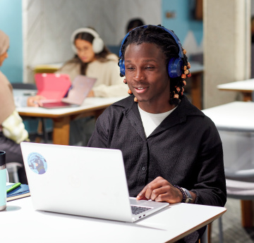 An image of a student watching an online webinar using a laptop.