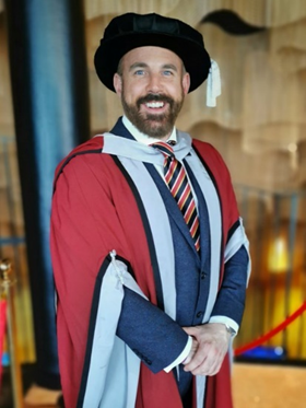 Man in a graduation gown and cap