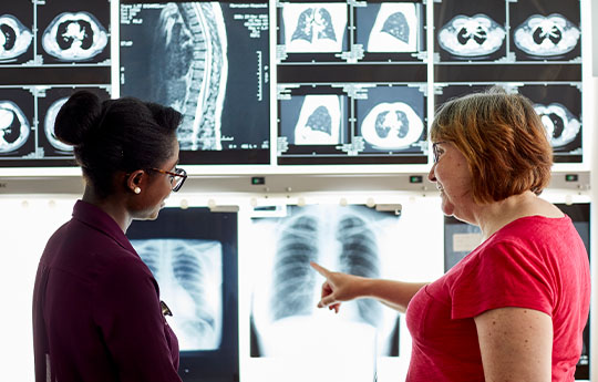 Student and Lecturer Examining X-rays