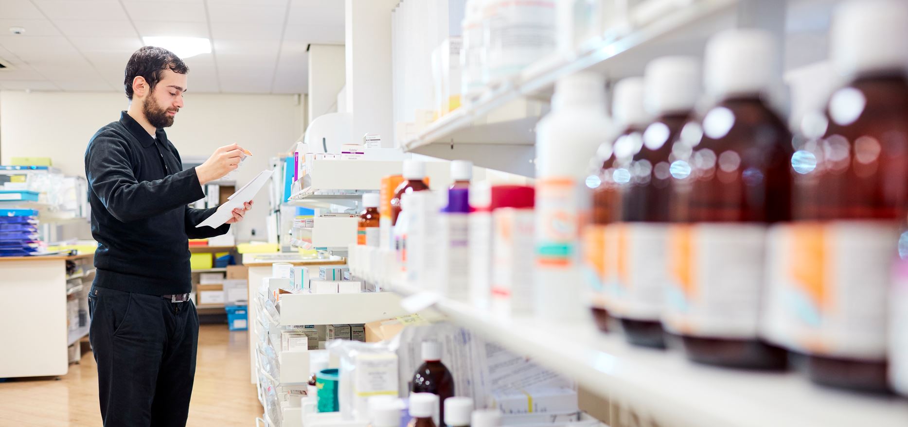 Pharmacist serving customer over counter 