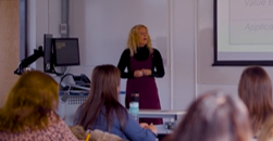 An image of a lecturer teaching in a seminar room. 