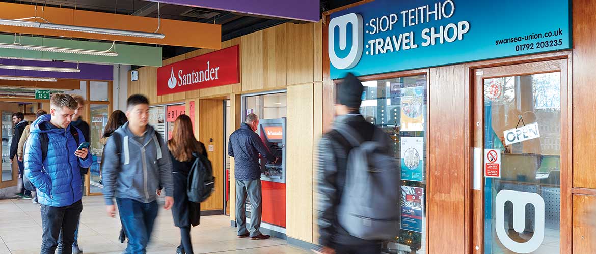 Students by the travel shop and bank