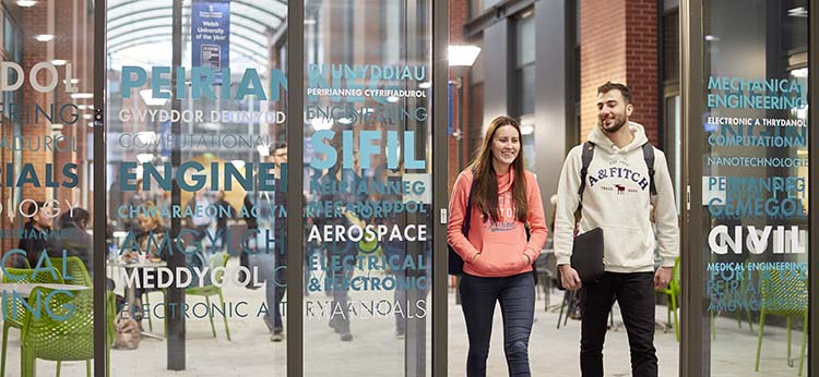 Students walking through a door in Engineering Central