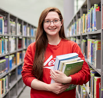 student holding books