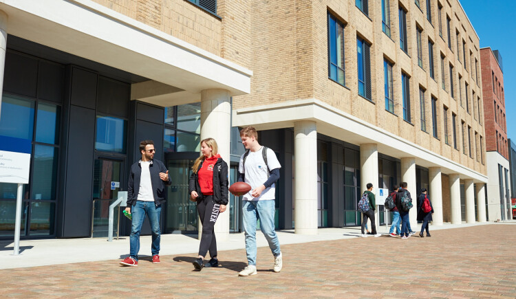 Students walking through Bay Campus