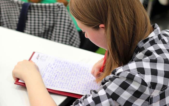 Young woman writing at a desk