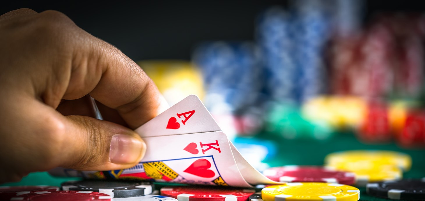 A photo of a person gambling, playing a game of cards.