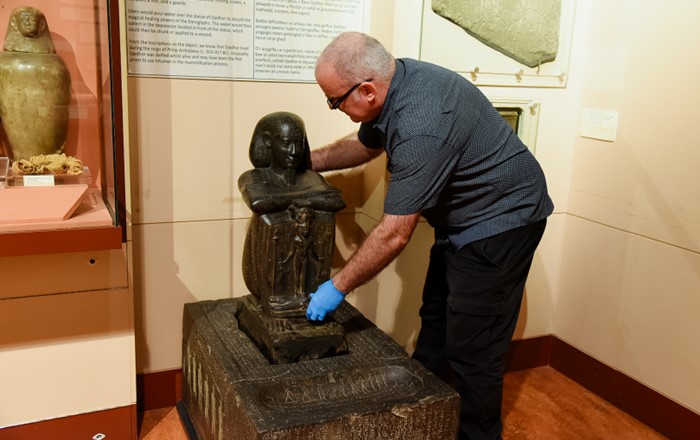 Dr Kenneth Griffin, Curator of the Egypt Centre, setting up the plaster cast of the statue base of Djedhor.