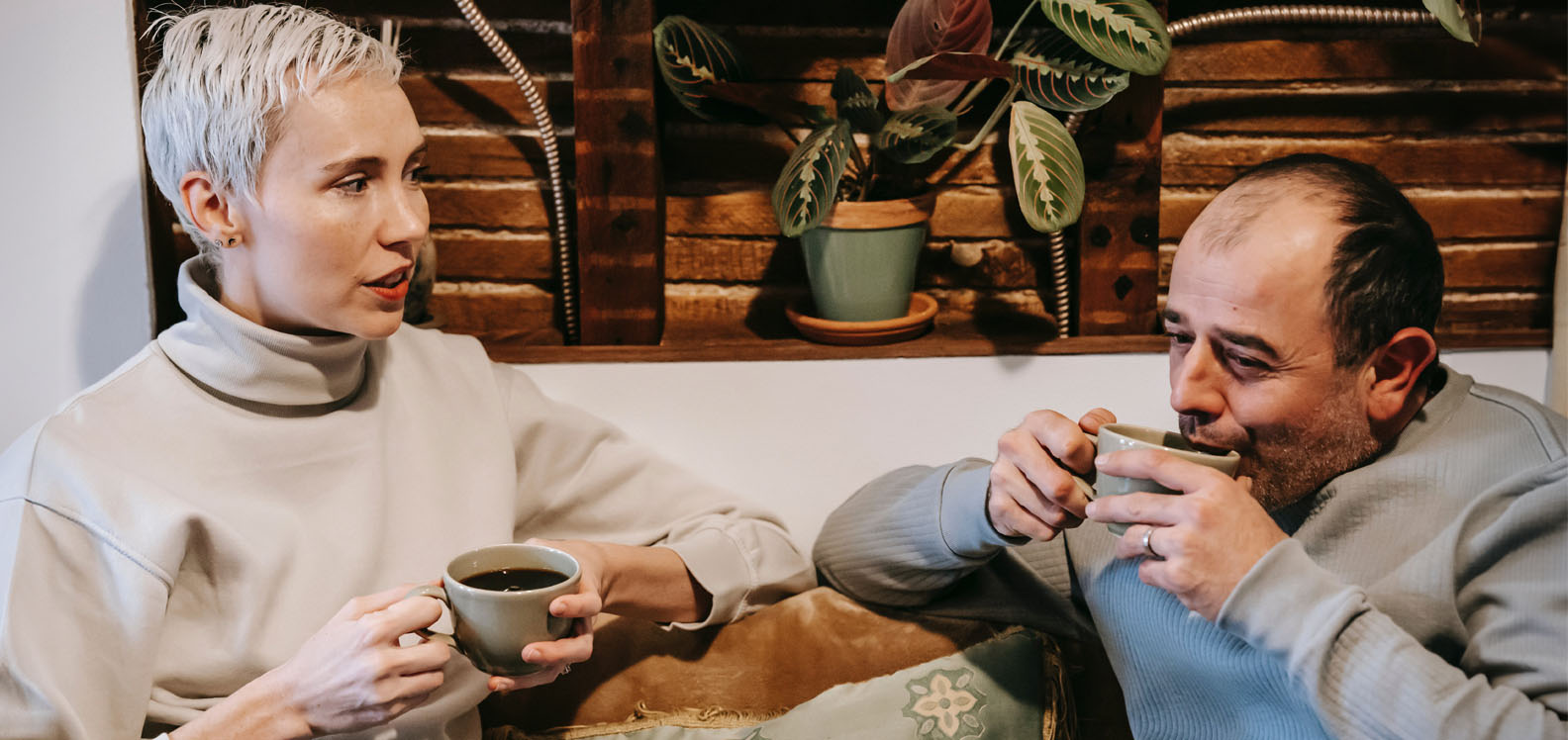 A woman and man sitting drinking a coffee