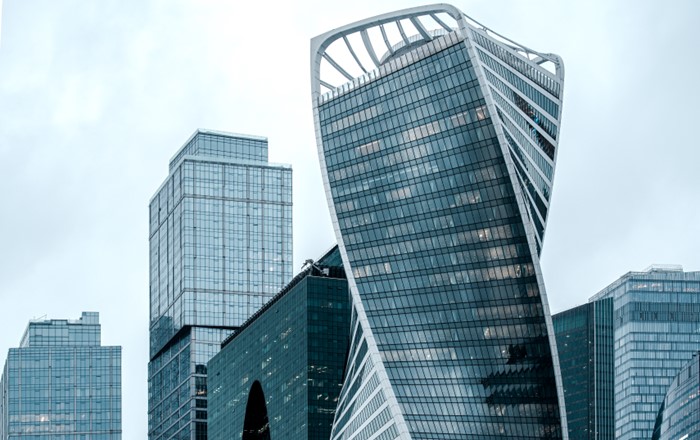 A complex of high-rise glass-fronted office buildings.