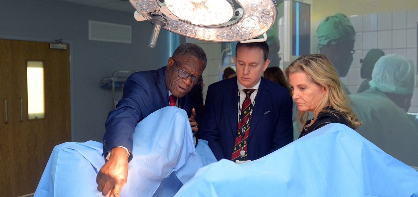 Two men and a woman in a surgical clinic.