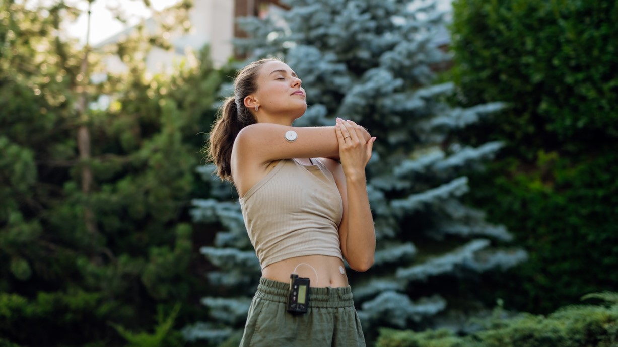 A photo of a woman using an AID system stretching before she exercises. Credit: Halfpoint