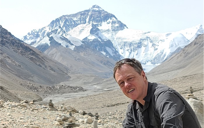 A photo of Professor Carl Cater during his trip. Mount Everest can be seen in the background.