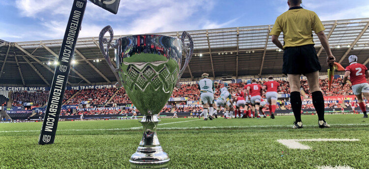 Welsh Varsity cup on the ground of a rugby pitch with players in the distance