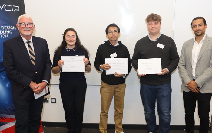 Two men standing either side of three young people holding certificates.