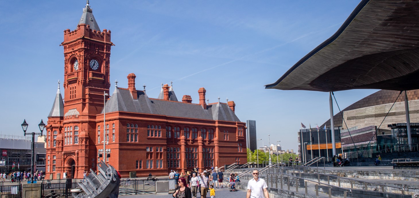 Exterior shot of Cardiff featuring red brick Pierhead Building alongside modern Senedd building