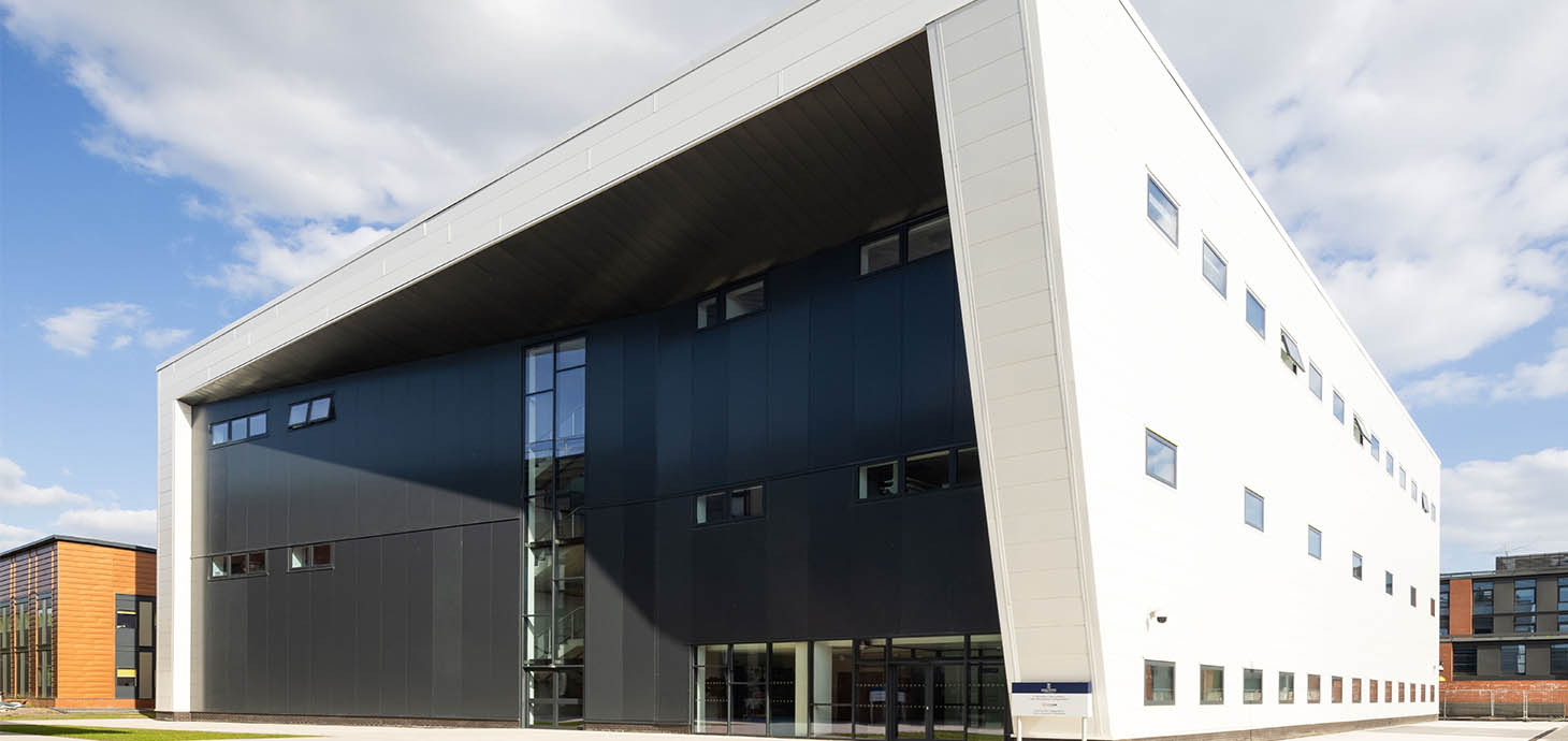 An exterior shot of the CISM building at Swansea University’s Bay Campus. The building is rectangular with black and white cladding.