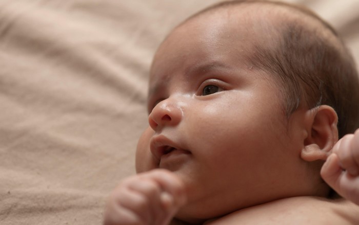 Close up of baby lying on a bed