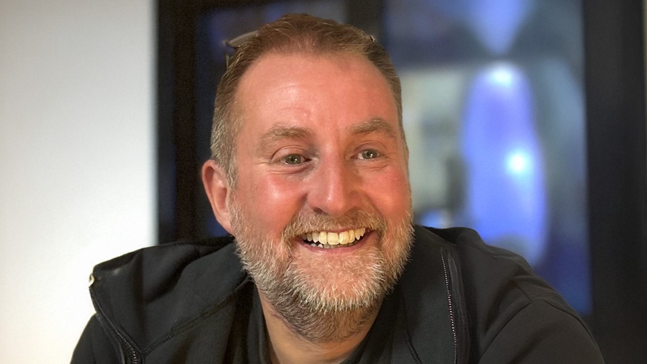 Head and shoulders of smiling man