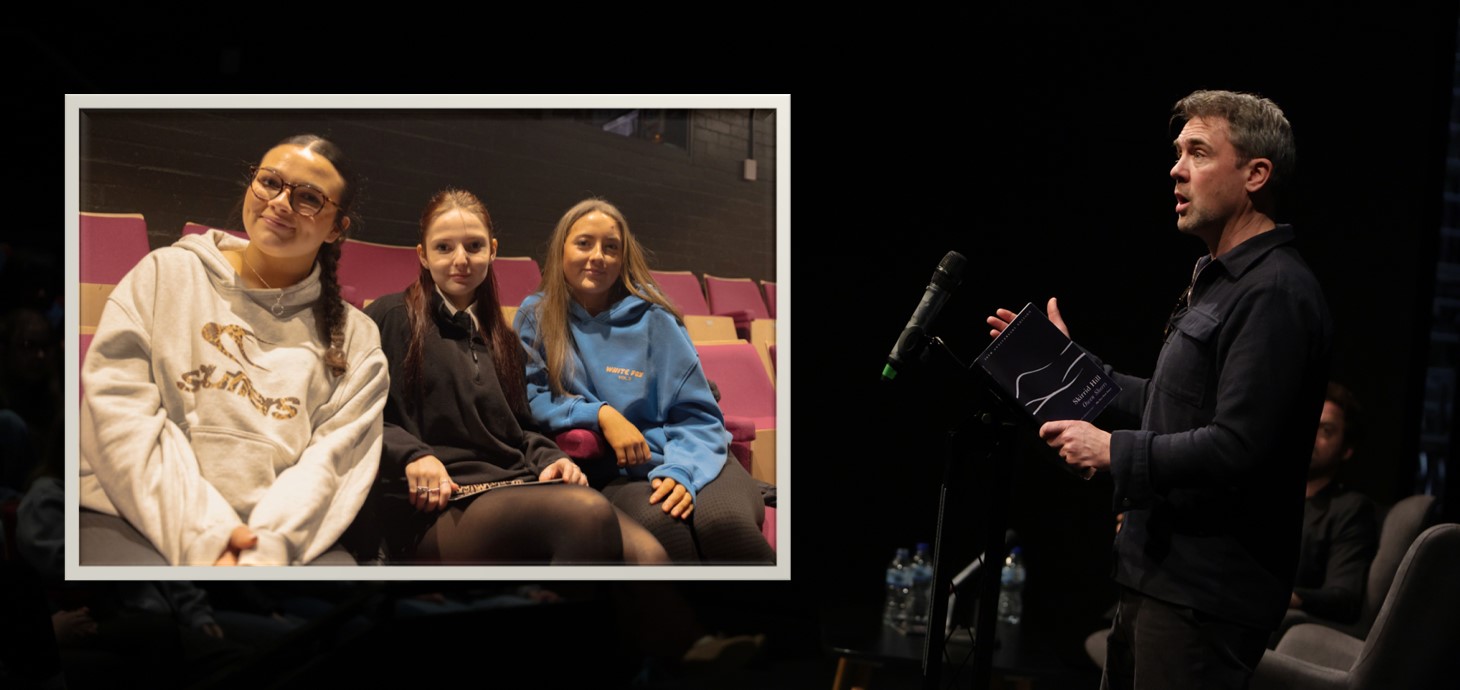 Man standing at lectern addressing an audience with inset picture of three girls sitting in a theatre