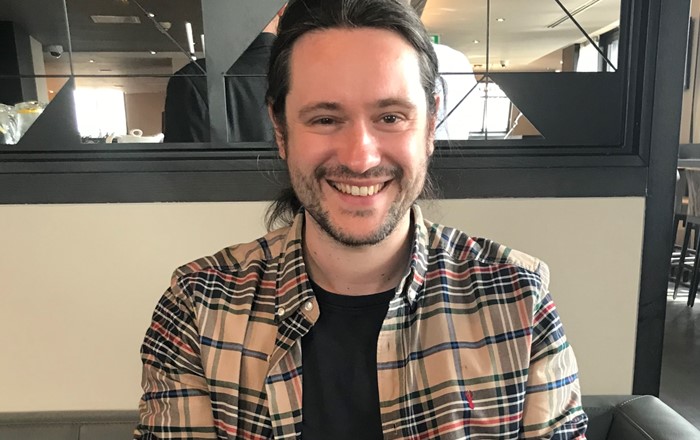 Smiling man sitting indoors