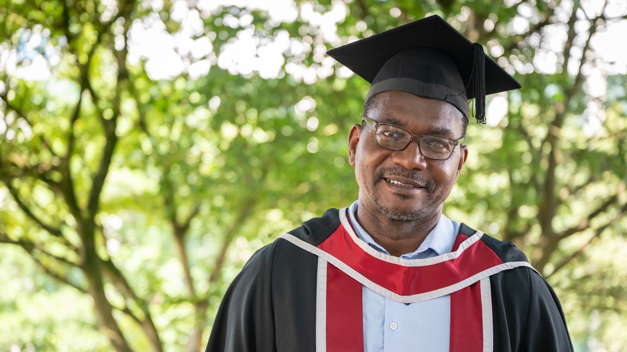 A photo of Joseff in his cap and gown at graduation.