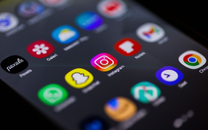 Close-up image of mobile phone screen featuring social media apps