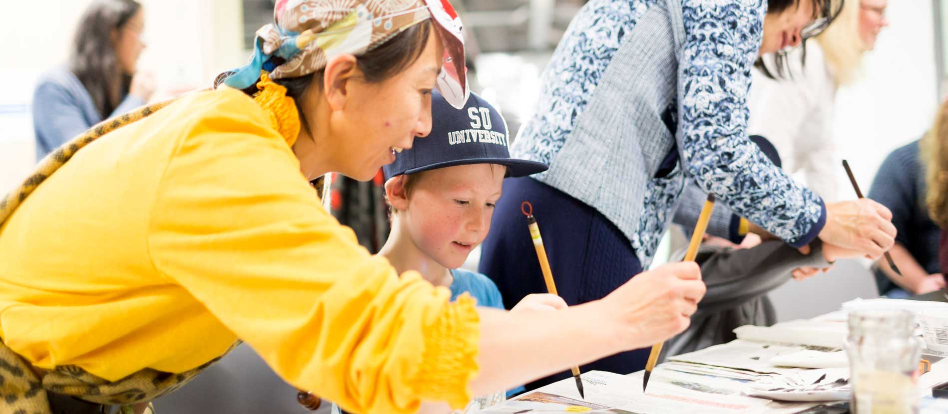 A photo of people drawing together.