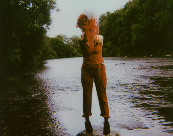 woman holding wool over her face