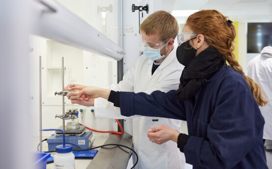 chemistry student and lecturer experiment