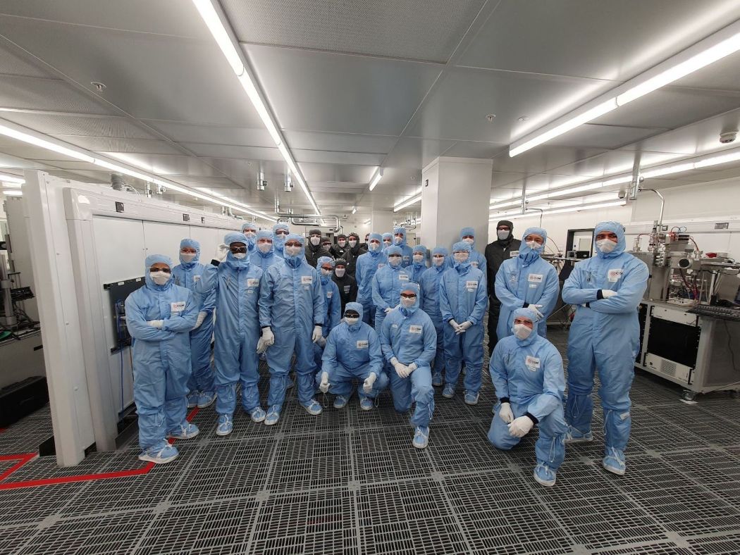 students in blue PPE in lab