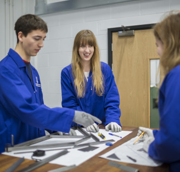 Group of students in blue lab coats 