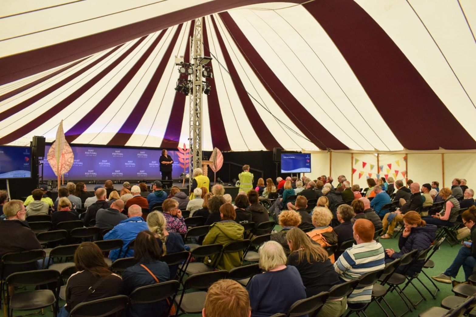 Lecturer talking to people in tent