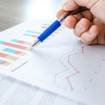 A person traces data graphs