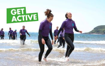 Get ACTIVE students walking out of the sea after a surfing session