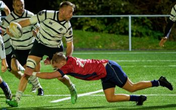 Image of sport scholar, Tom Boggemann, tackling opponent during rugby fixture. 