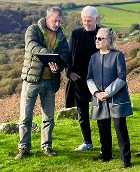 Alex Langlands with Bill and Hillary Clinton examining the medieval landscape