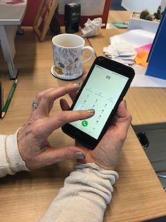 Woman calling 999 on her mobile phone