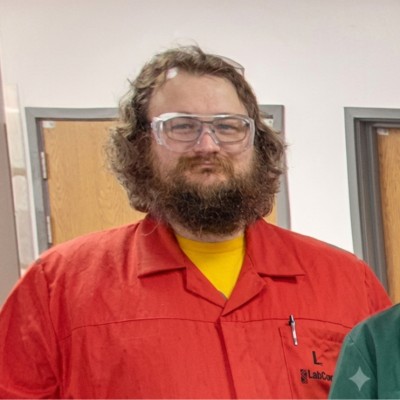 A picture of Steve Shearan, wearing a red lab coat. 