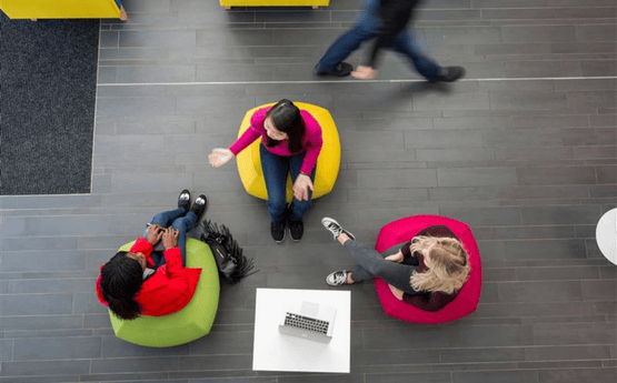 Aerial shot of students discussing on bean bags.